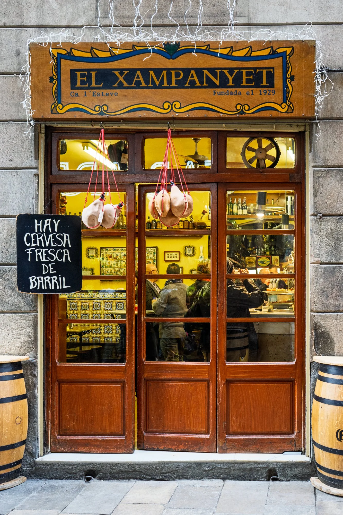 El Xampanyet, a tapas bar in El Born, Barcelona, founded in 1929, with hams hanging over the door