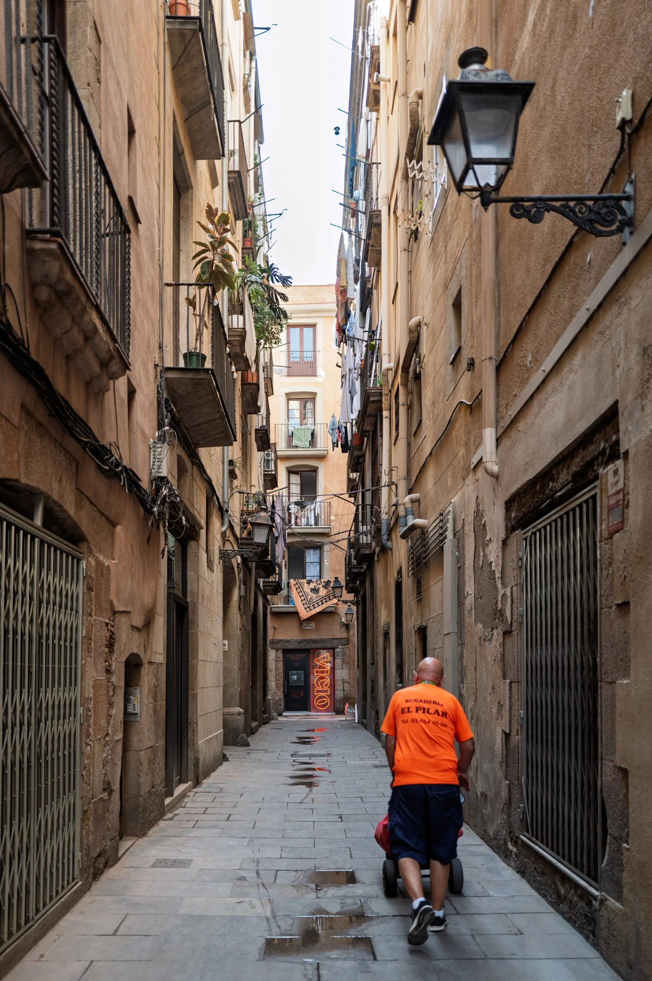 Neon bar sign glowing in narrow medieval alley, El Born — Leica Q3