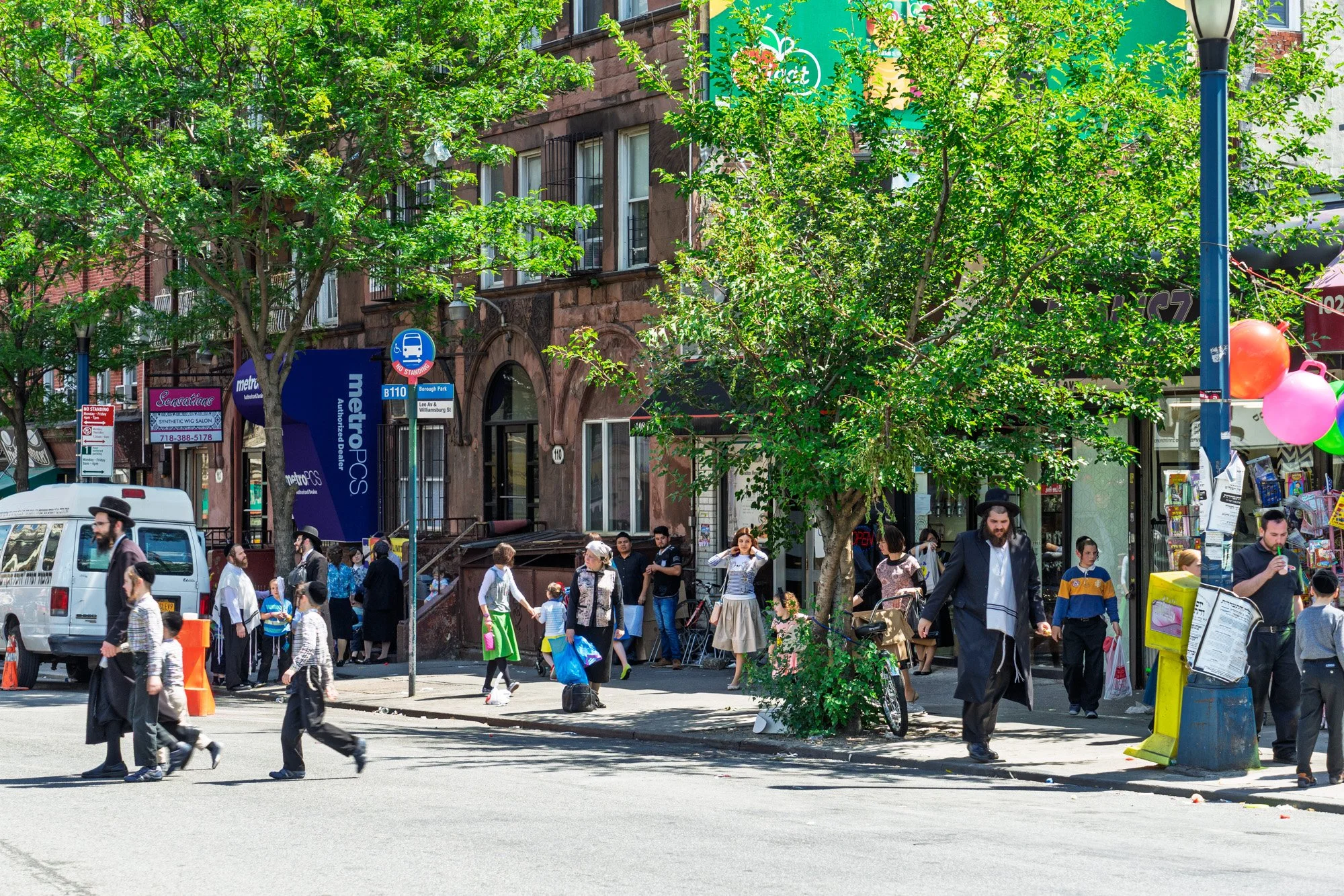 Busy street scene on Lee Avenue with crowds and balloons, South Williamsburg Brooklyn — Sony a7II
