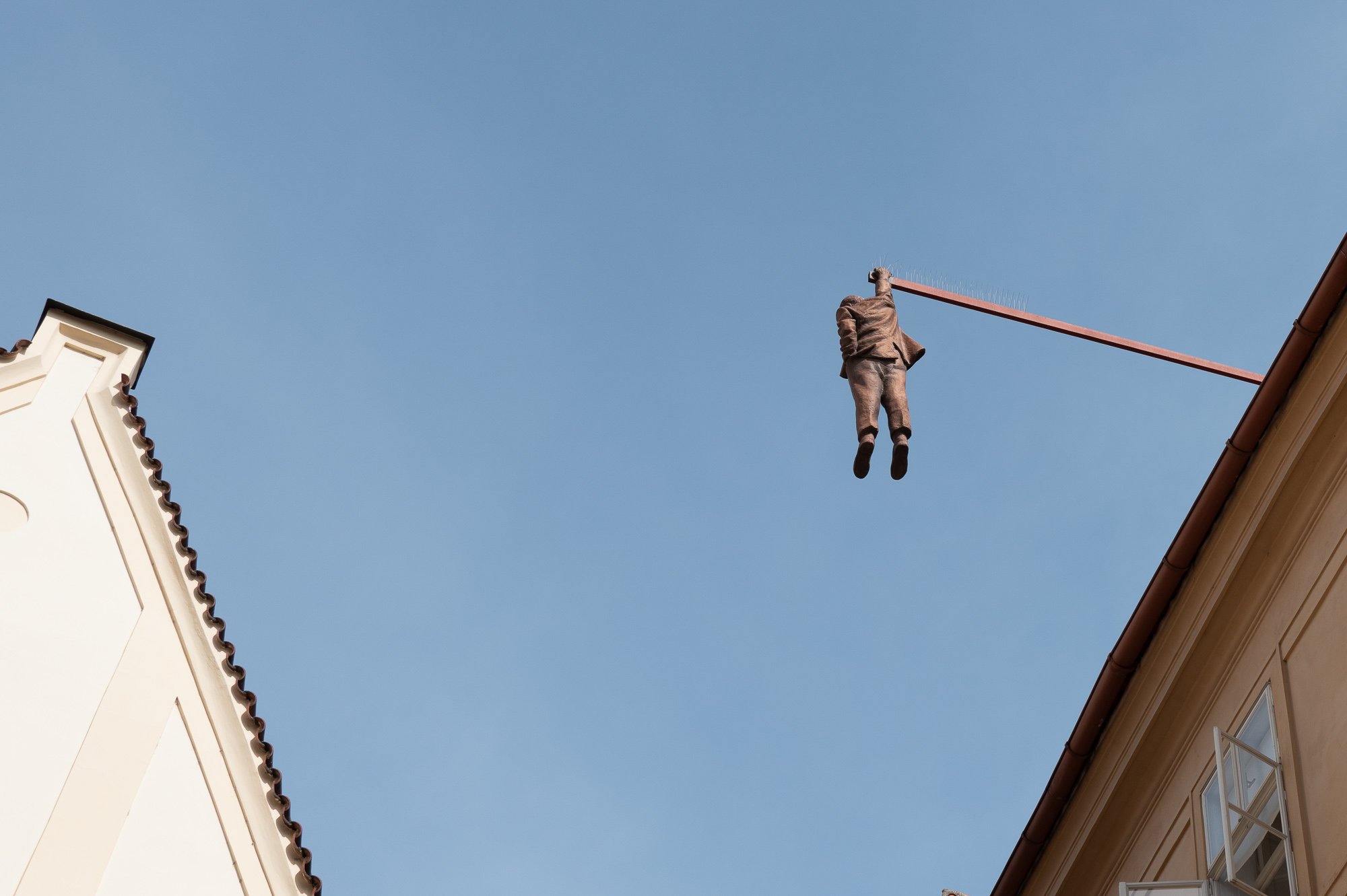 David Černý's sculpture of Sigmund Freud hanging from a beam above Husova Street, Prague — Leica Q3