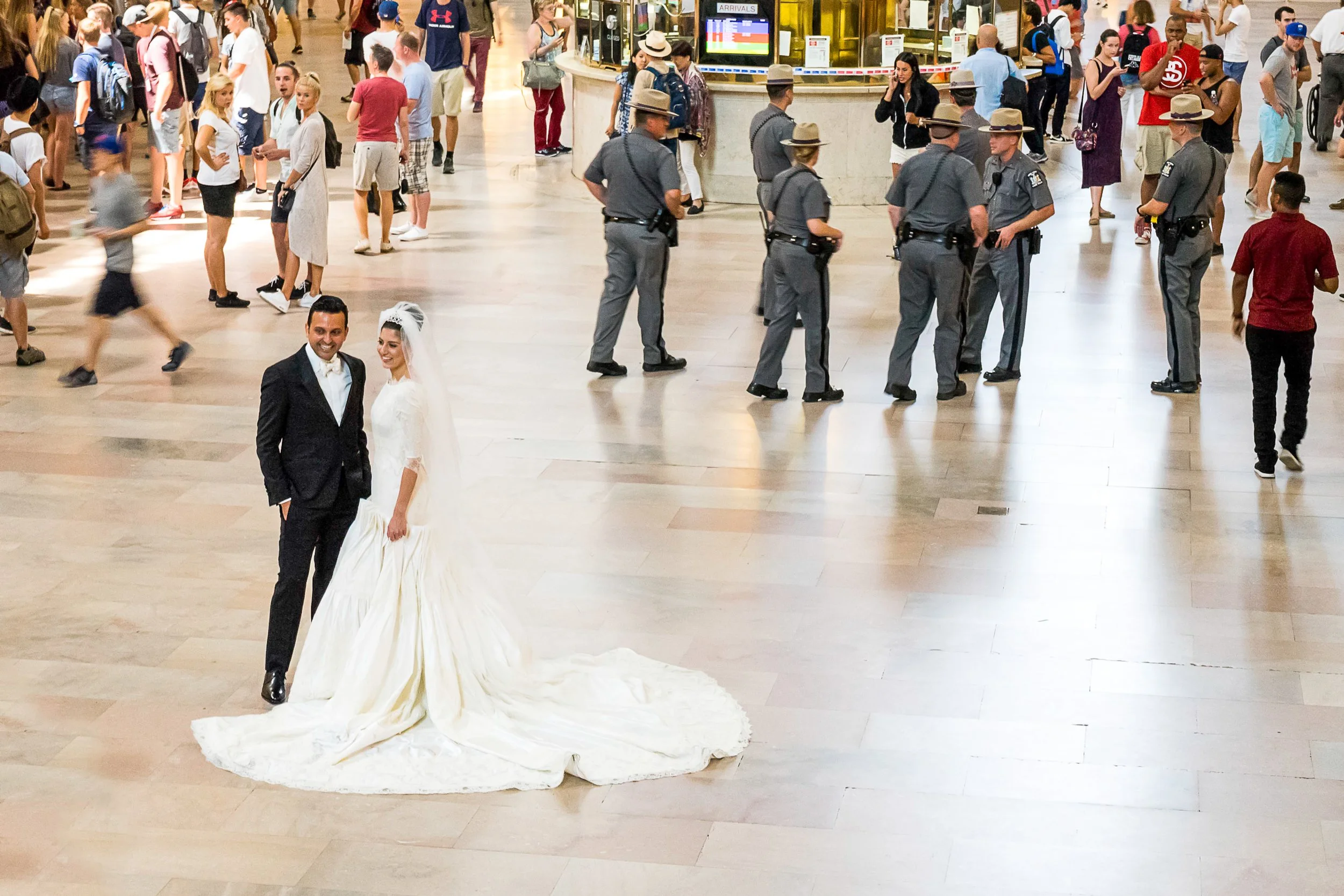 Bride and groom at Grand Central Terminal with police officers in the background – street photography – bCLPhoto