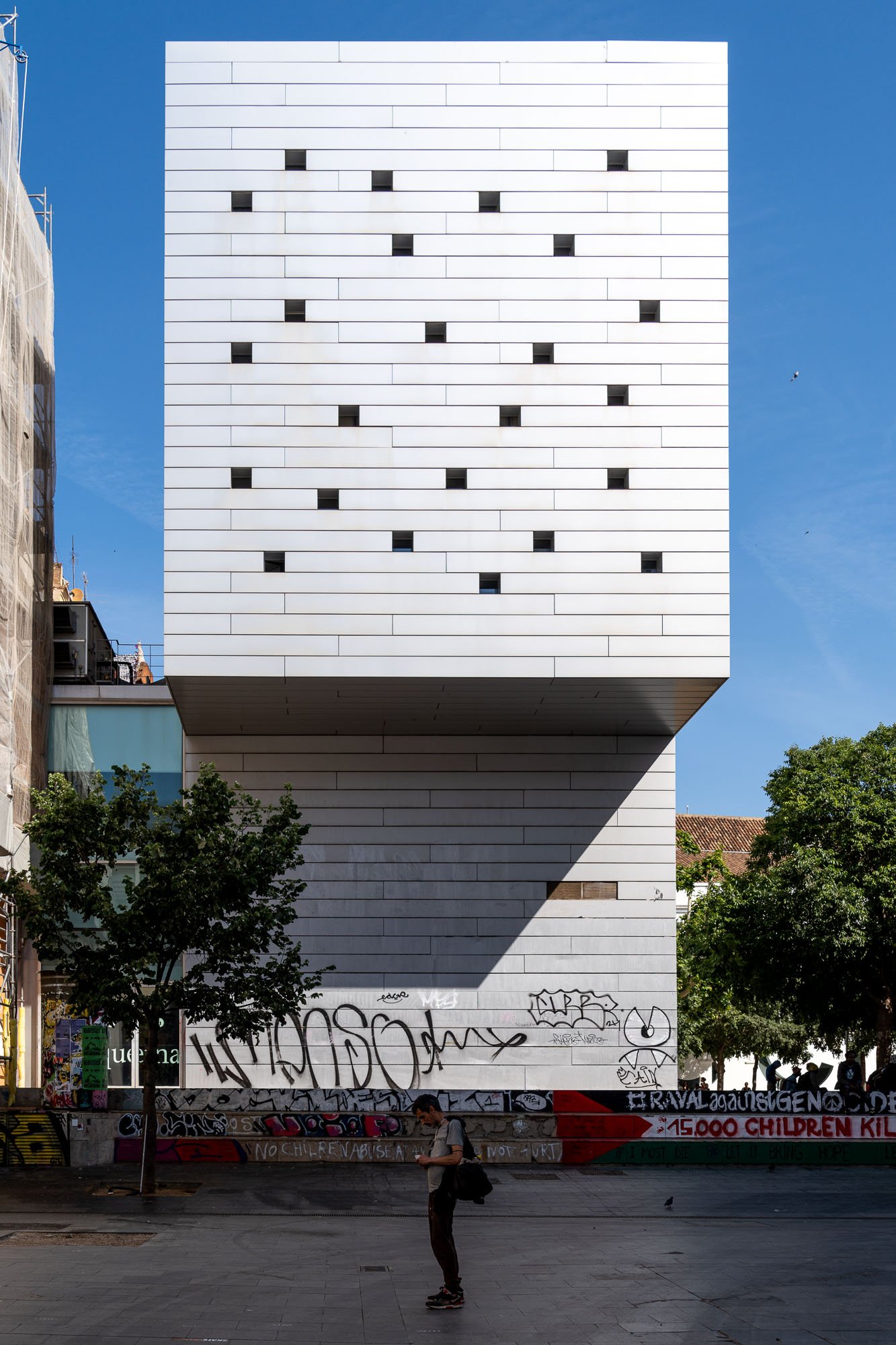 White building over graffiti walls in El Raval, Barcelona street photography spot — Sony a7R IV