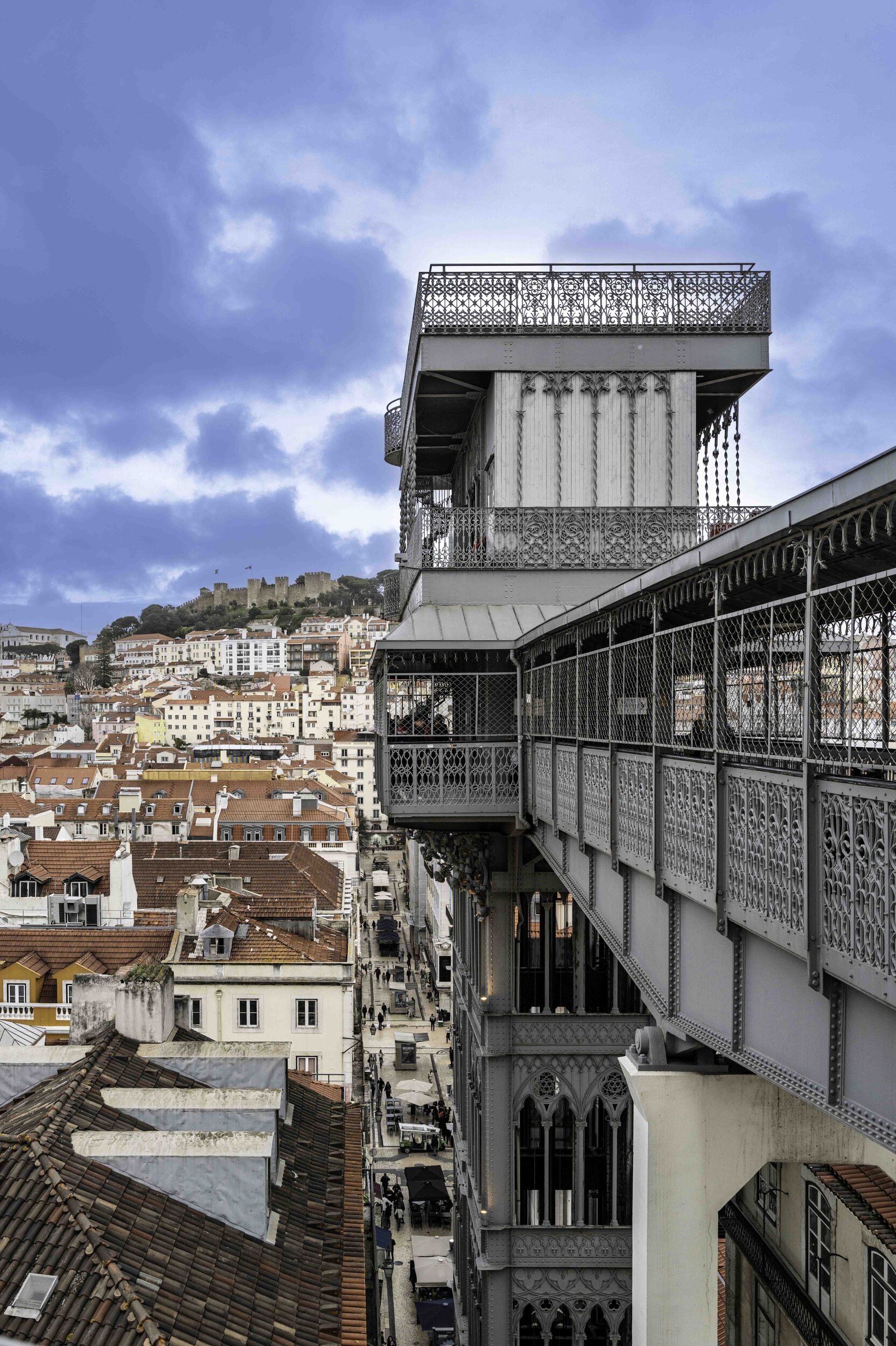 View from Elevador de Santa Justa over Lisbon rooftops toward São Jorge Castle — Leica Q3