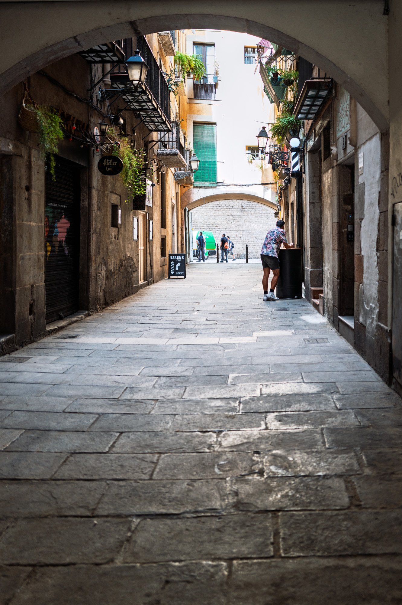 Barber atelier storefront under stone arcade, El Born Barcelona — Leica Q3