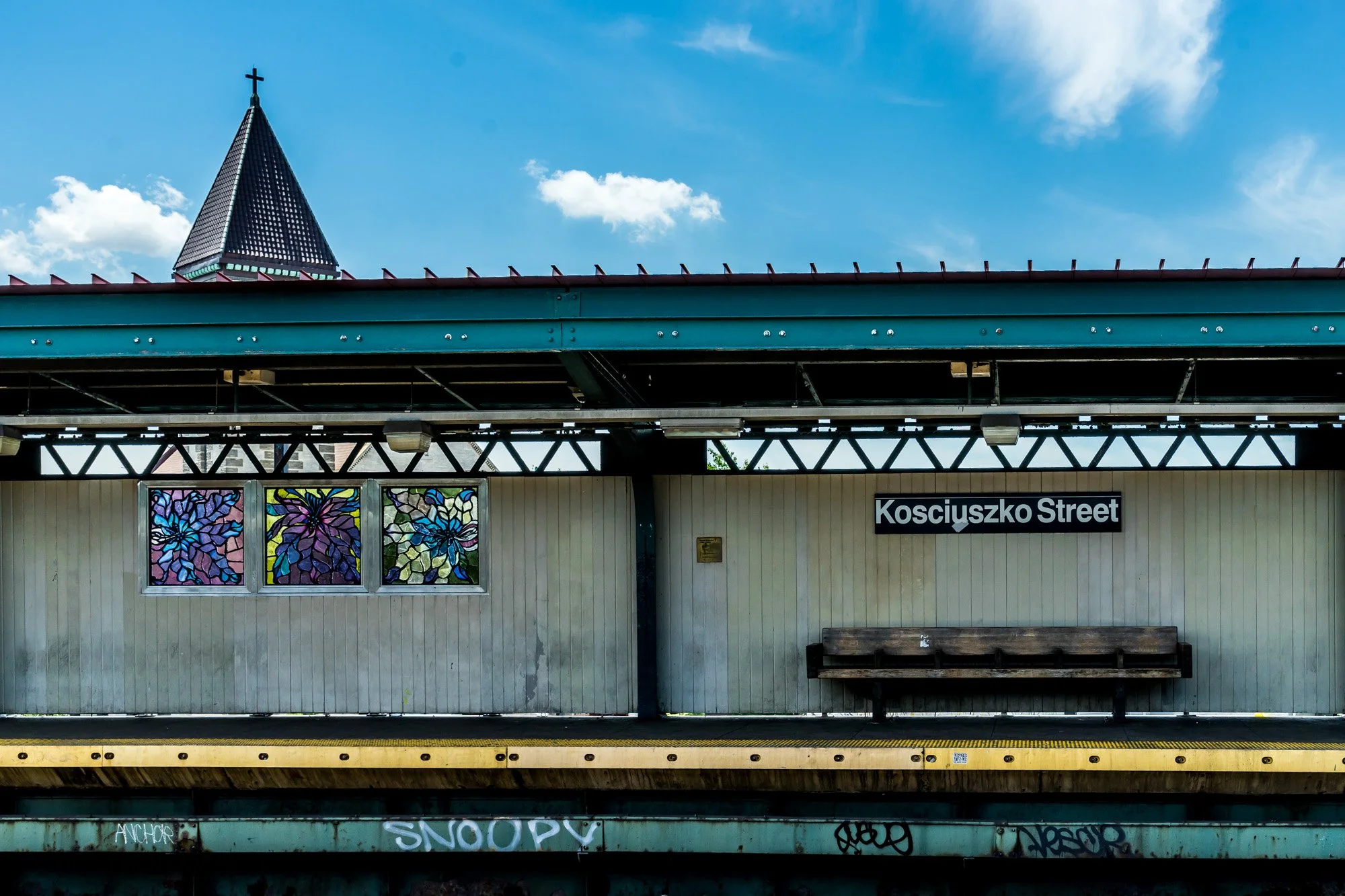 Kosciuszko Street elevated subway station with stained-glass panels and church spire, Brooklyn — Sony a7II