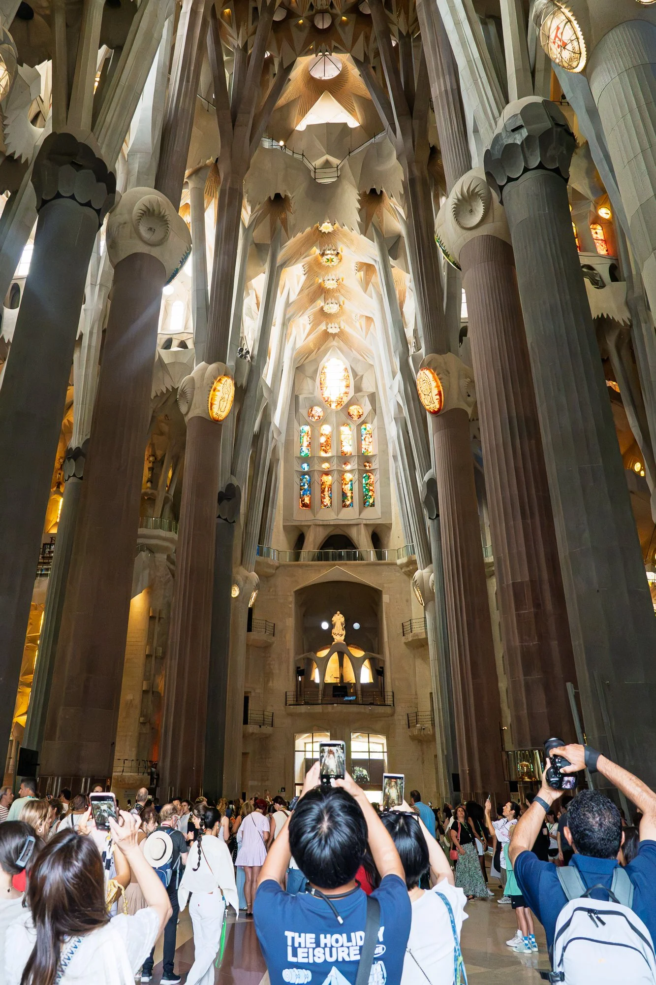 Crowd raising phones and cameras inside the Sagrada Família  — bCLPhoto