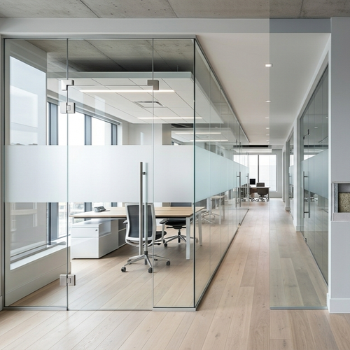 modern office with glass partition wall and natural light