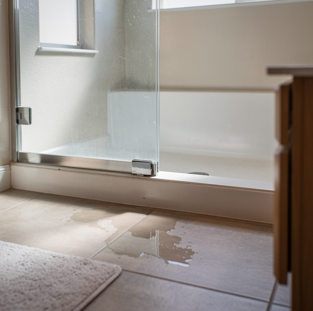 Sliding glass shower door in compact bathroom