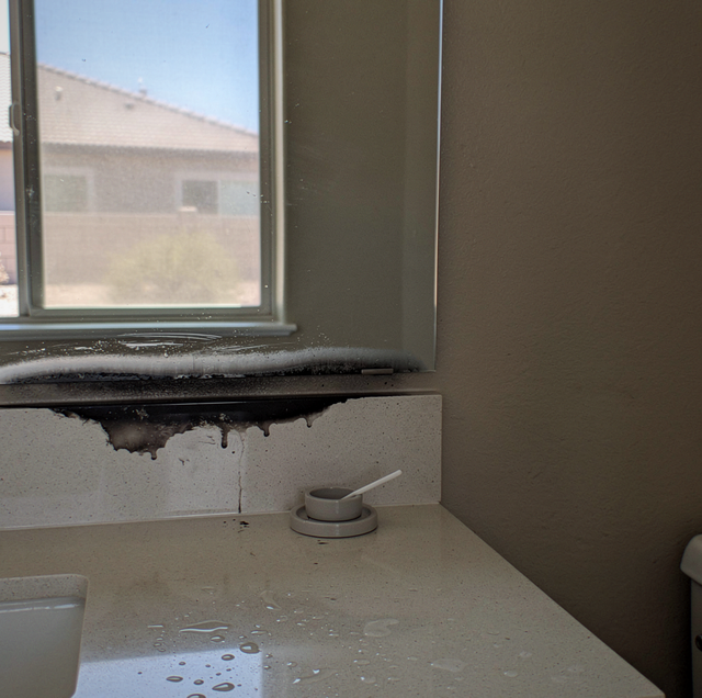 black edge corrosion spreading from screw hole on mirror