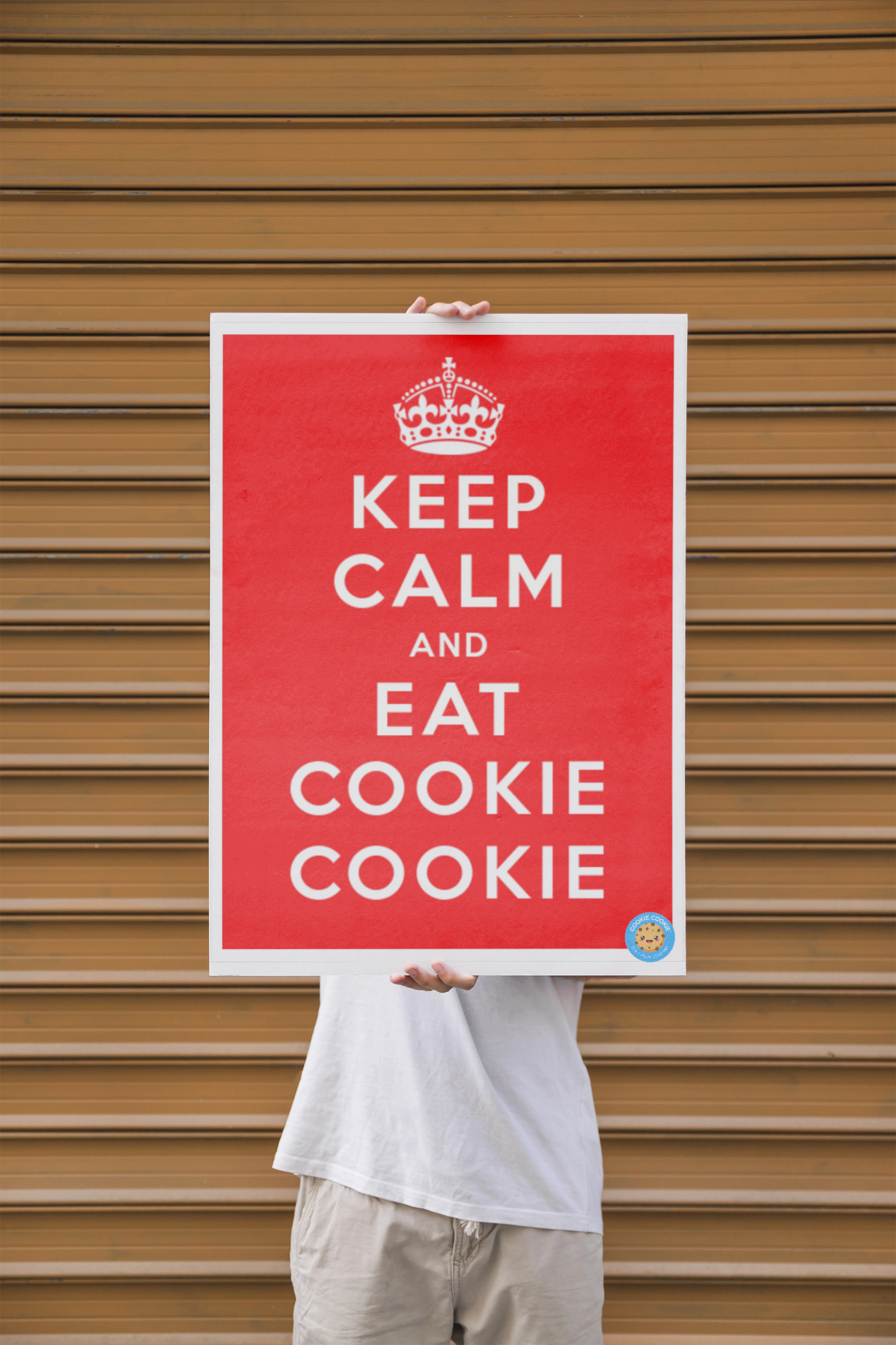 Man presenting poster mockup in front of wall.png