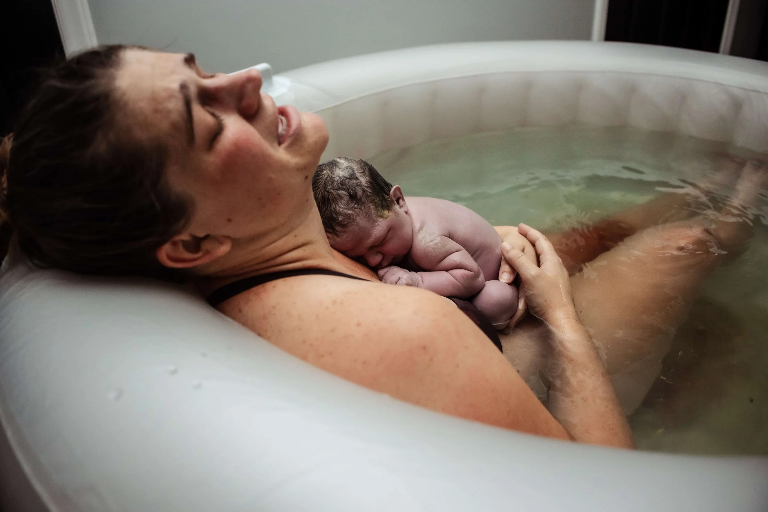 Happy mother and baby after a calm, waterbirth in Chapel Hill NC