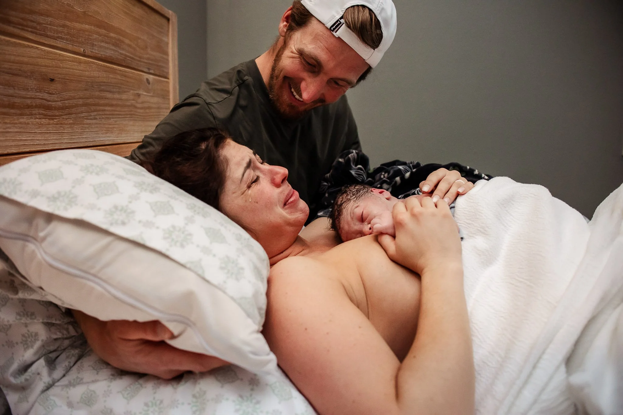 Happy mom enjoying skin to skin after natural  birth at Haven Birth Center in Cary NC