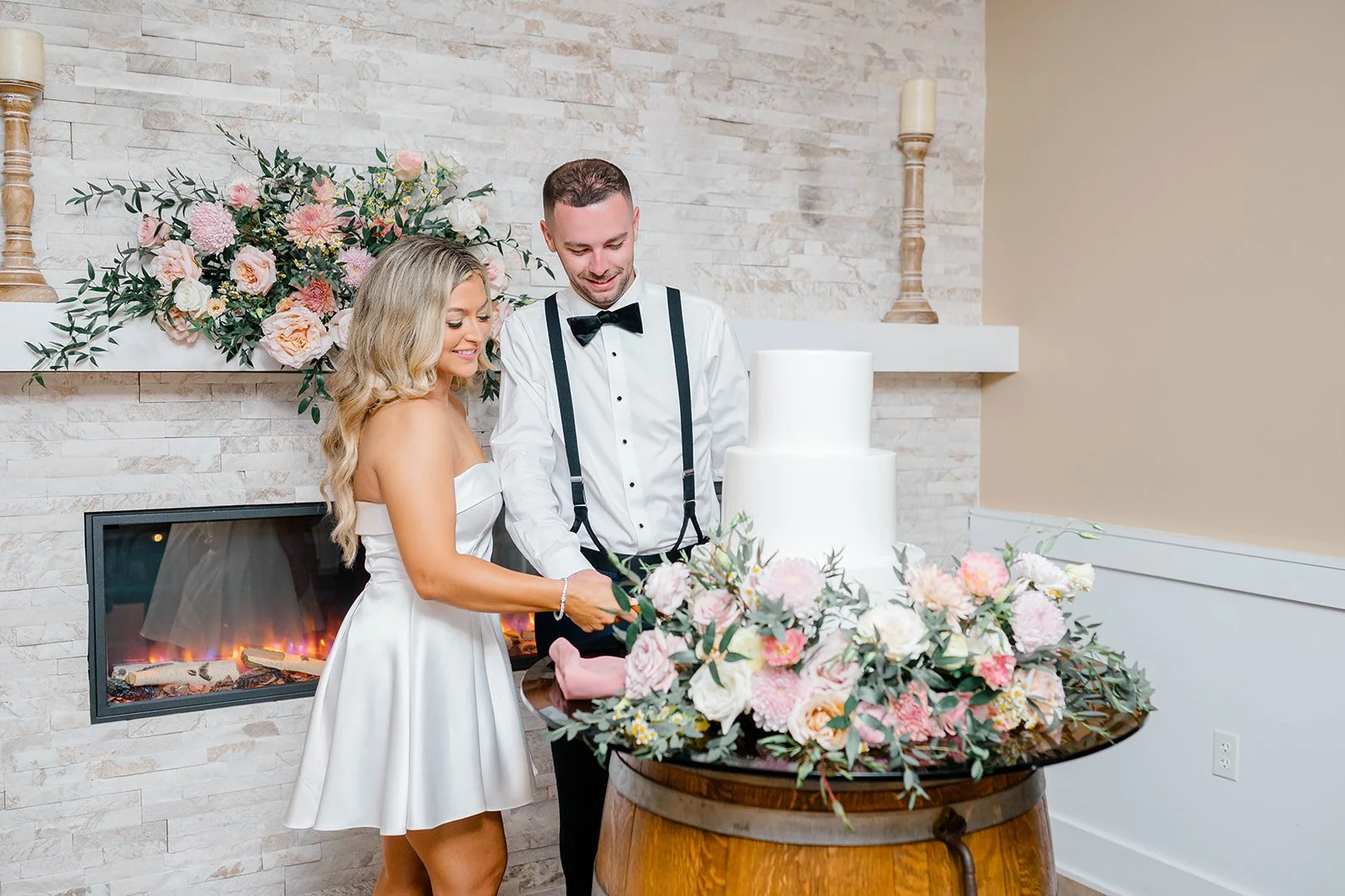 Bride and groom sitting at sweetheart table in the ballroom.