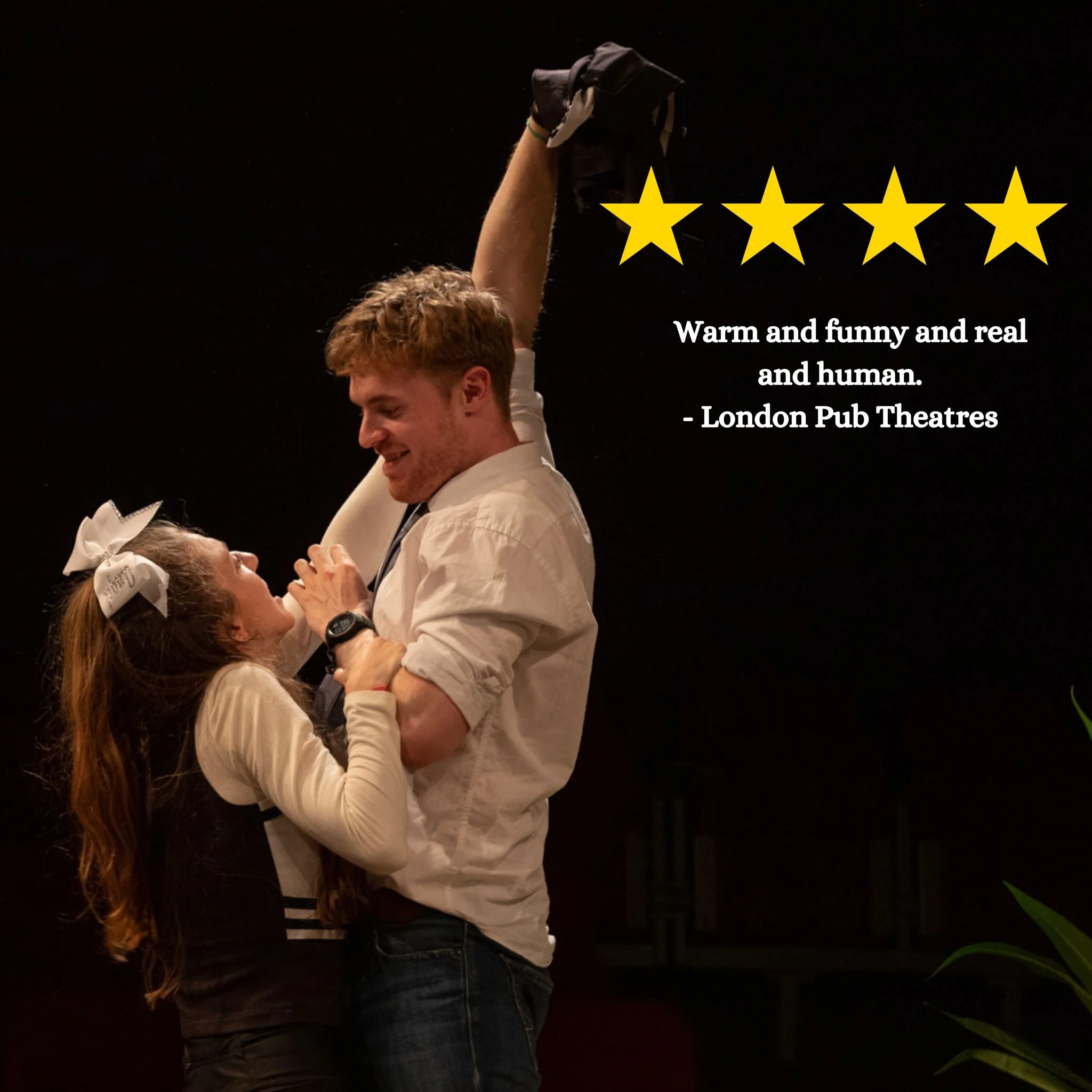 A young man and woman together, smiling. The girl is wearing a black and white cheerleader outfit, reaching up for neon underwear in the man's hand. He wears a shirt and jeans.  A 4 star review with a quote "Warm and funny and real and human" beside.
