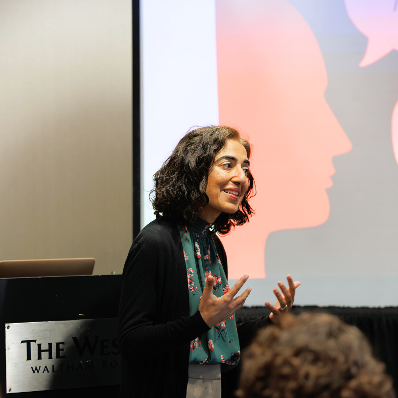 Indu Singh, founder and principal consultant of Door 21 Consulting, giving a presentation to a group of school leaders.