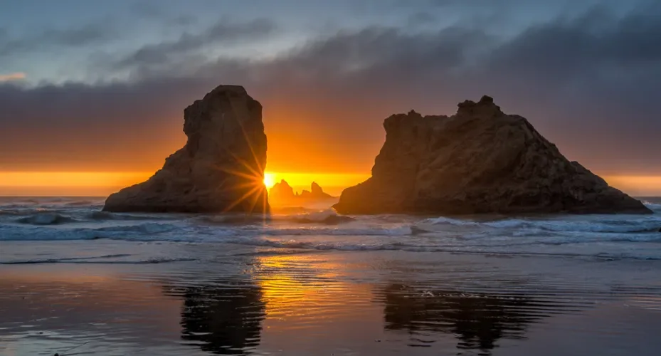 Golden sunset light illuminating sea stacks along the Oregon coast photographed during a Wake Up To Adventure coastal landscape photography tour.