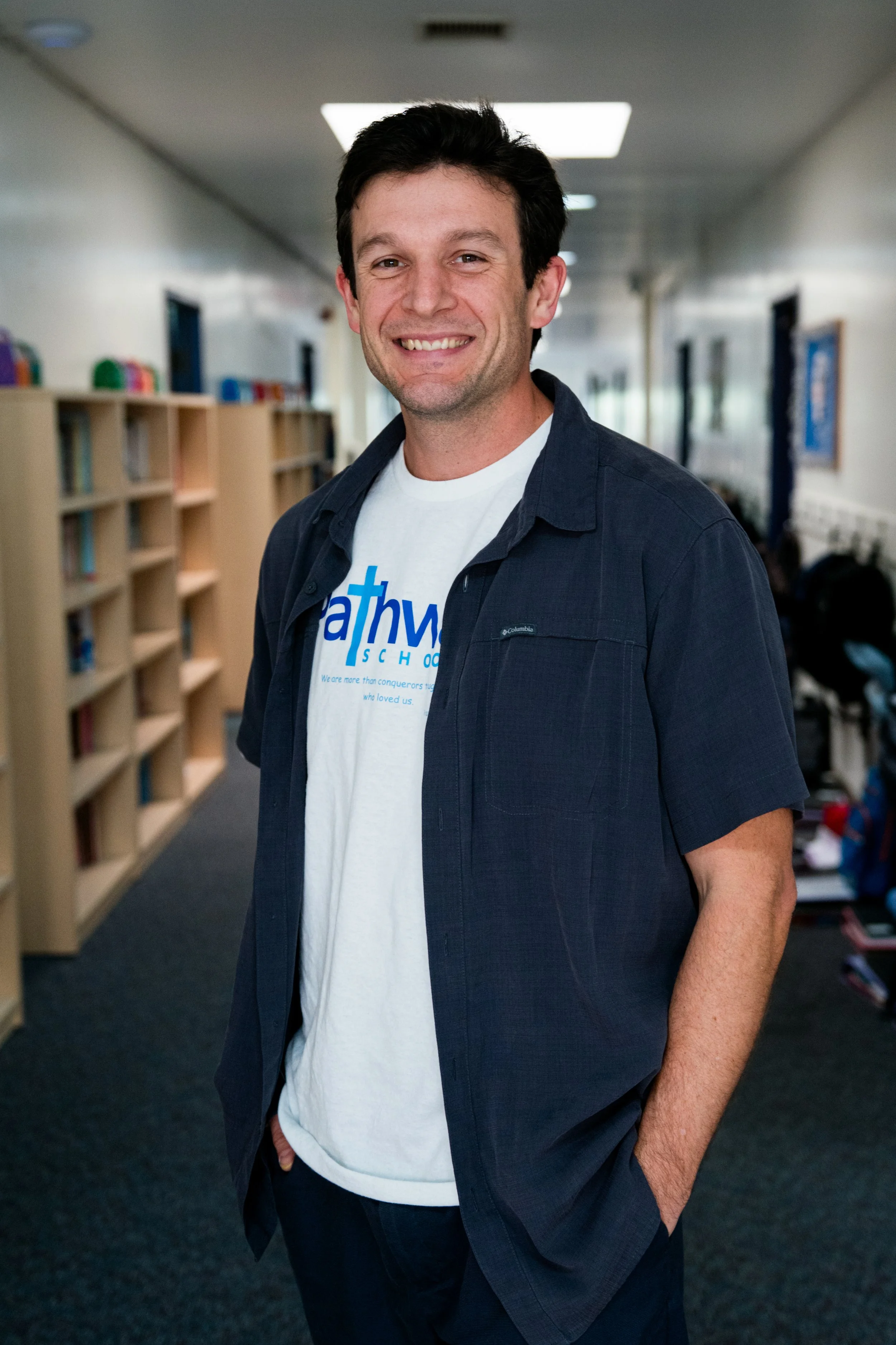 Blue sign with yellow curved lines, displaying the text 'Pathway Staff' in white, bold font