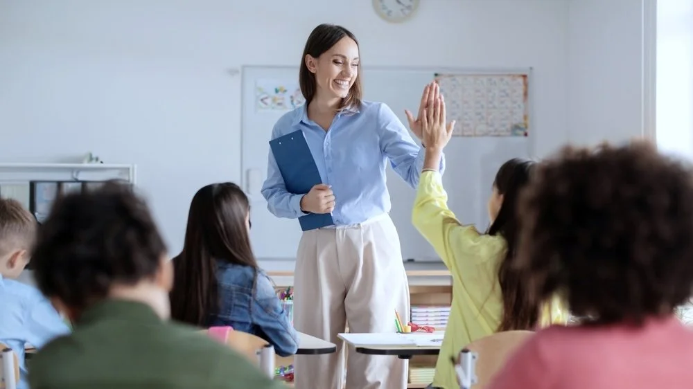 Teacher high five with a neurodiverse student
