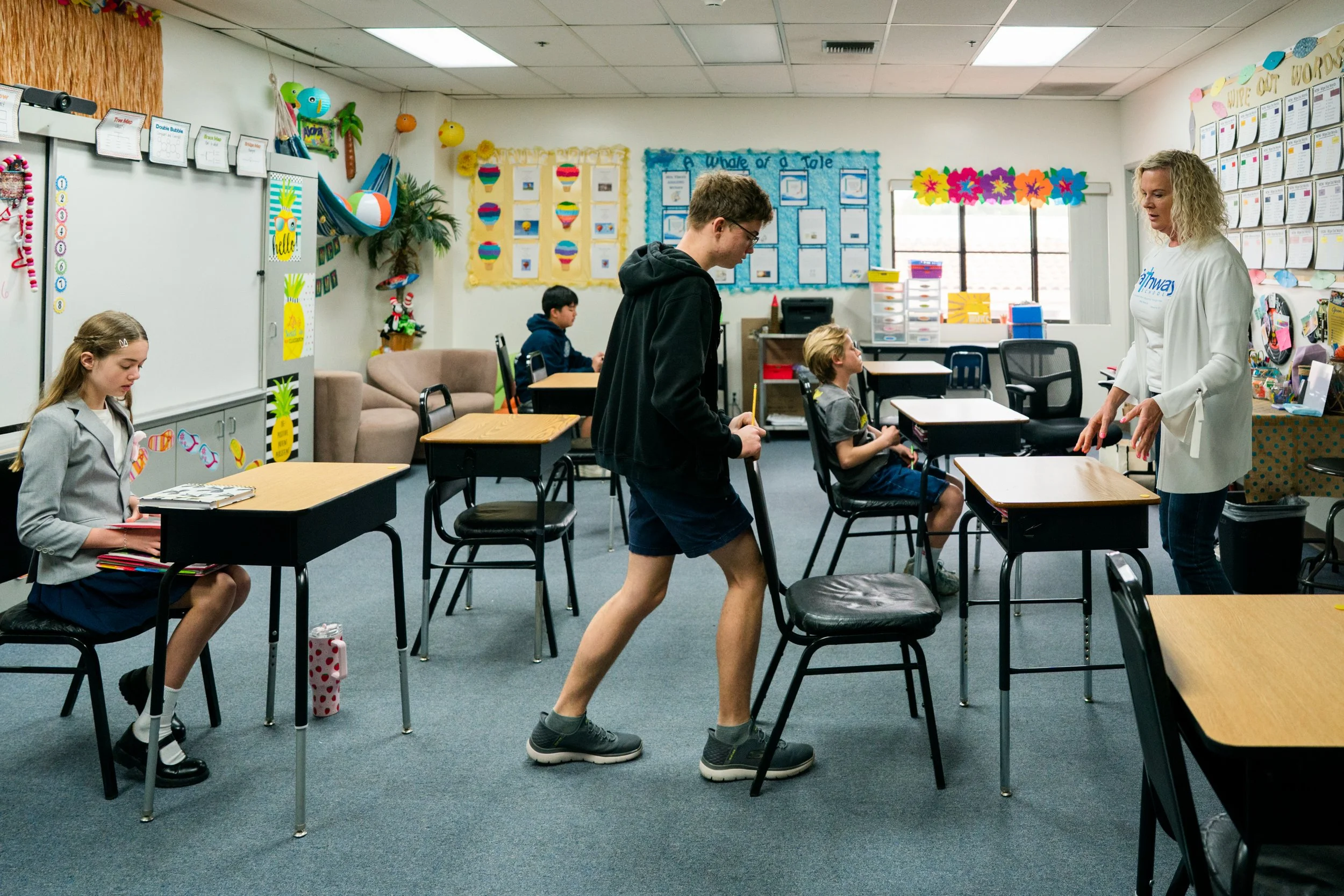 Students and a teacher in a bright, small Pathway classroom