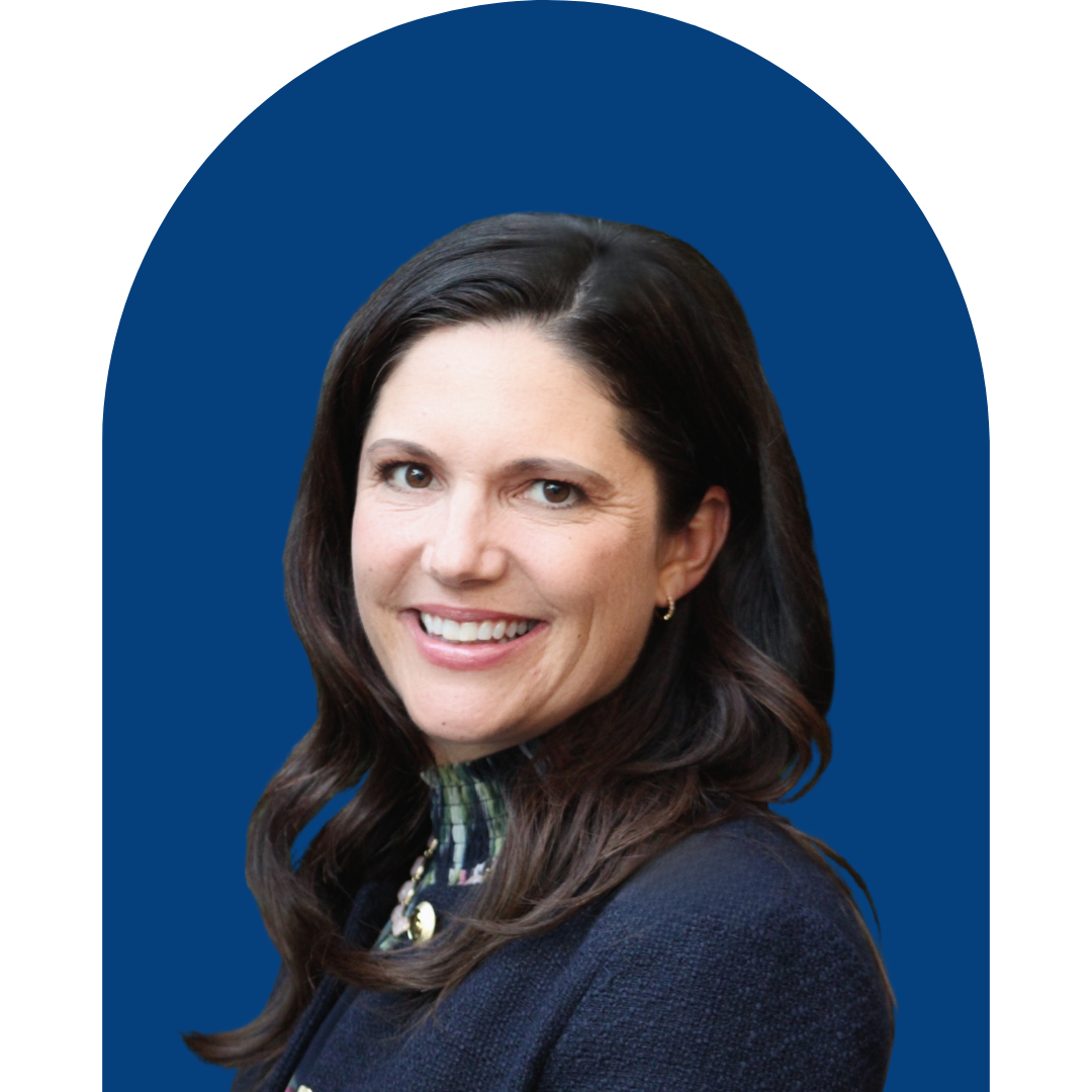 A professional woman with long dark hair, smiling, wearing a dark blazer against a blue arched background.