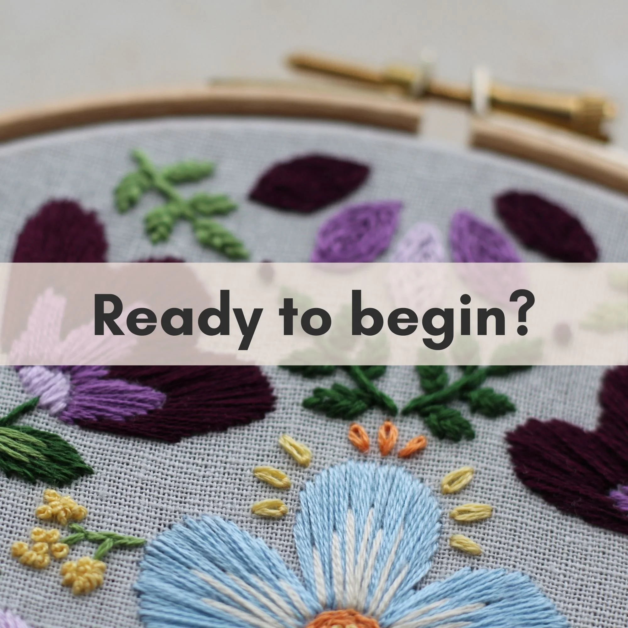 Finished Penelope floral hand embroidery hoop featuring folk style flowers stitched with satin stitch and French knots.