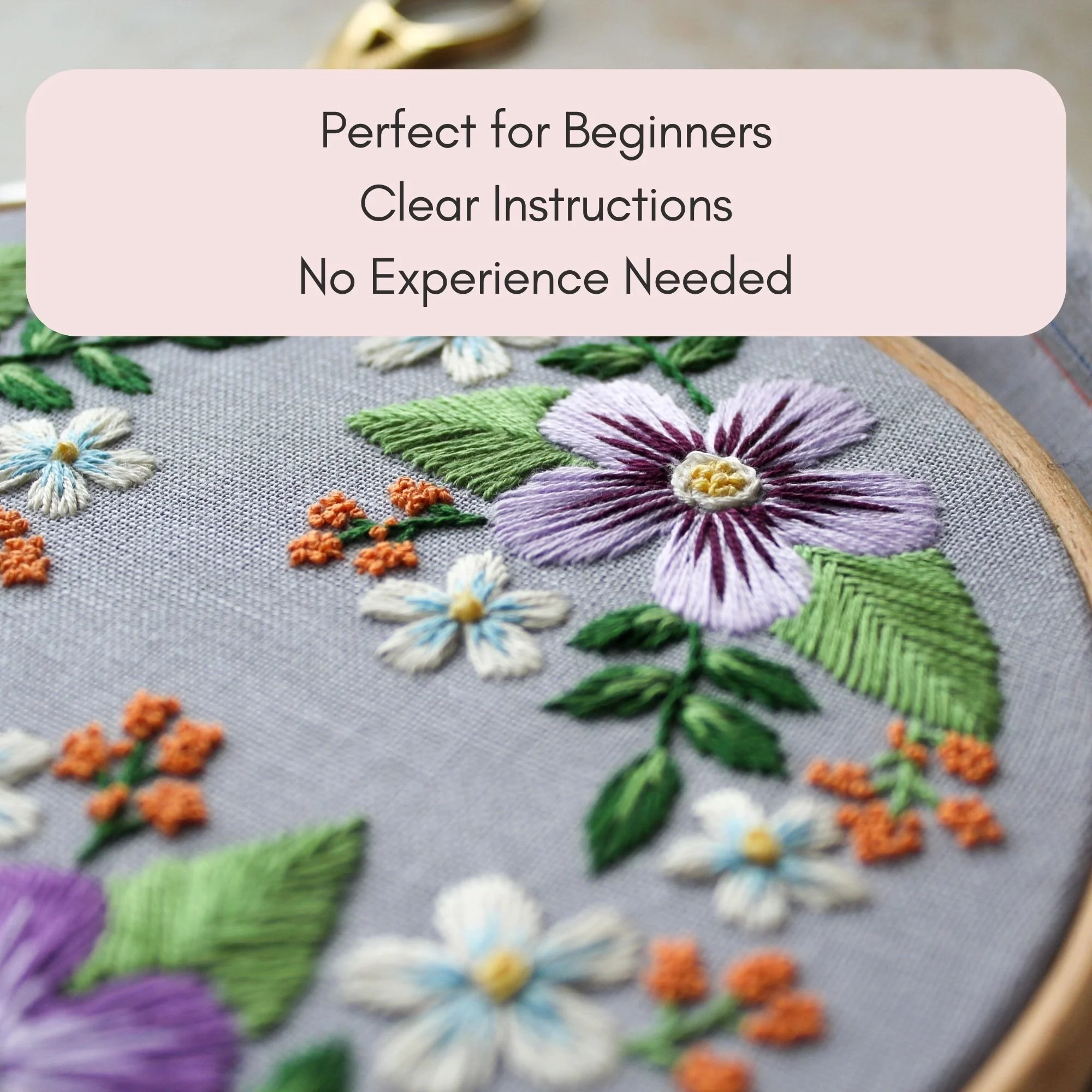 Floral embroidery hoop with purple and white flowers, beginner-friendly hand embroidery pattern for mindful stitching.