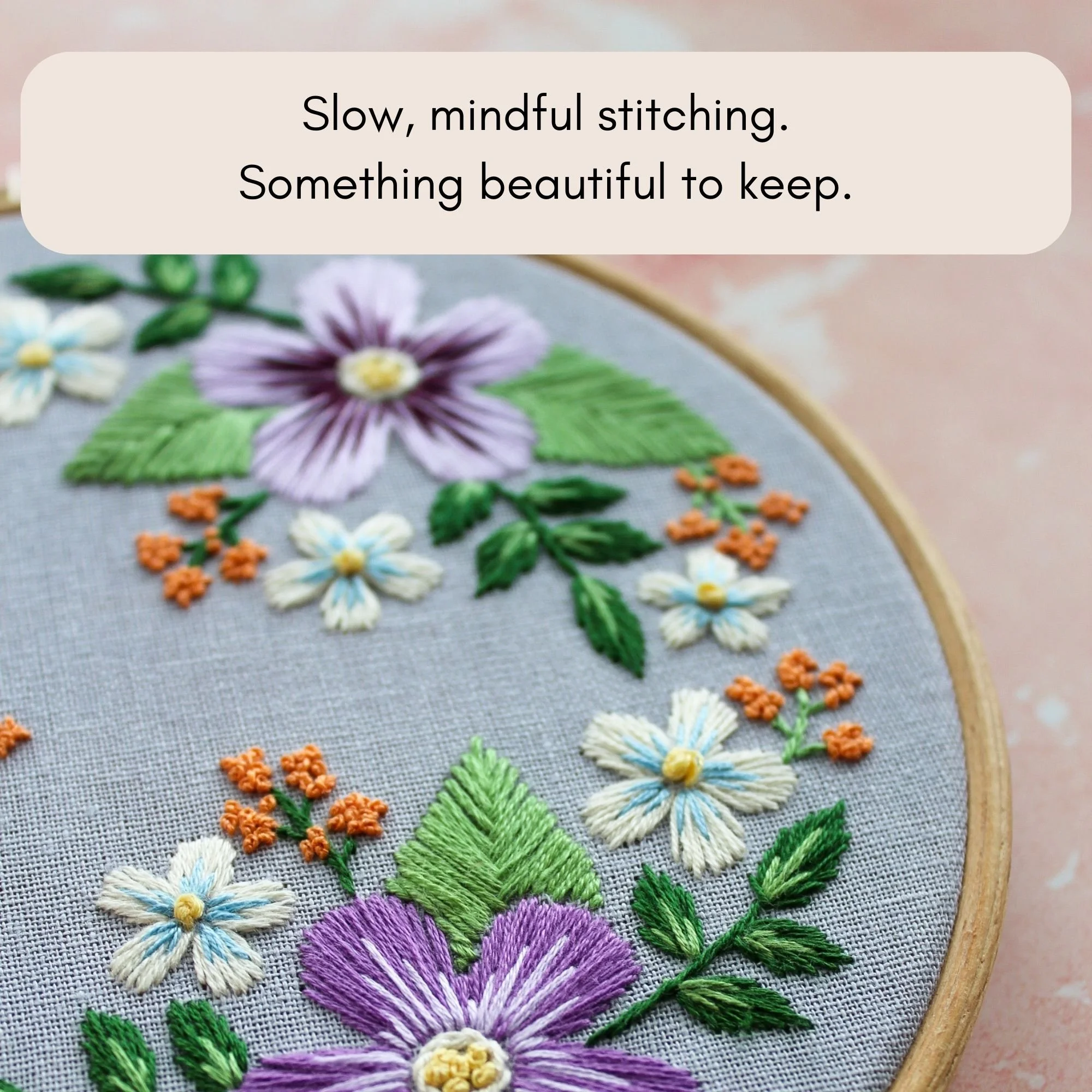 Floral embroidery hoop with soft purple and green folk-inspired design for slow, mindful stitching project.