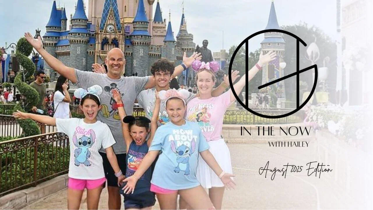 Hailey Gillum Caduff poses with arm raised up alongside her family, all enthusiastically posing in front of the iconic Disney castle with the HG In the Now logo overlayed on top.