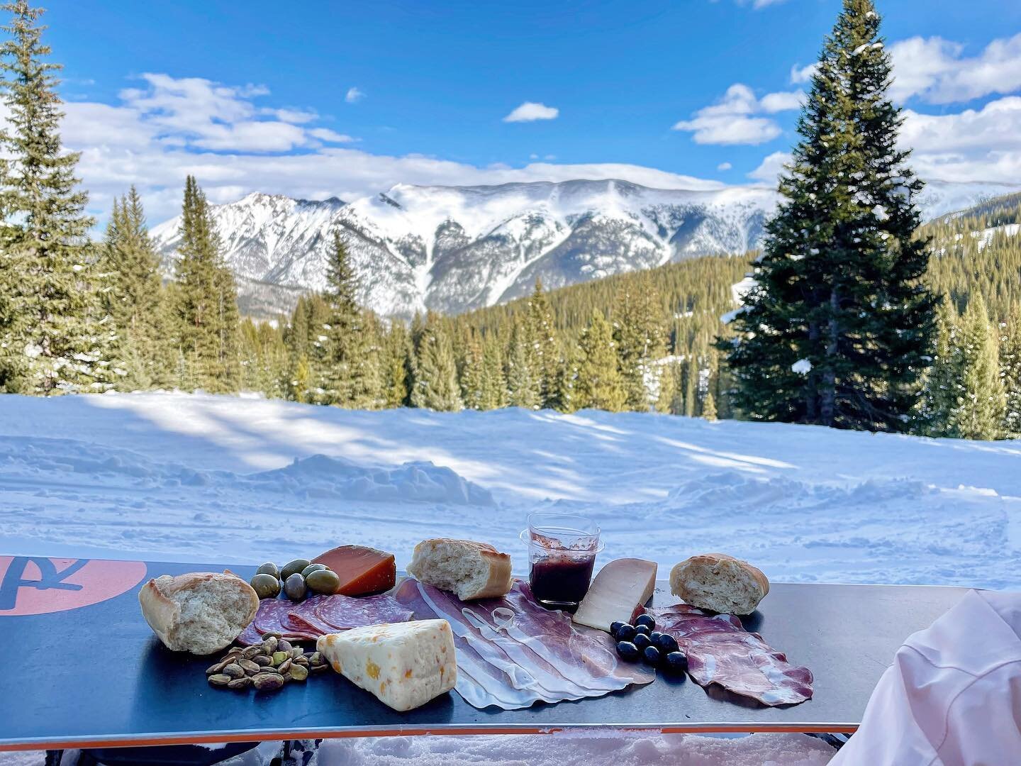 A Ewephoric day on the slopes. 
&bull;
Apricot Stilton, Mimolette, Ewephoria goat cheese, Prosciutto, Coppa, Salame, Fig Jam, Italian Bread, Pistachios, Olives, Brookside A&ccedil;a&iacute; &amp; Blueberry, and Kaleidoscope Red Blend on a Rossignol s