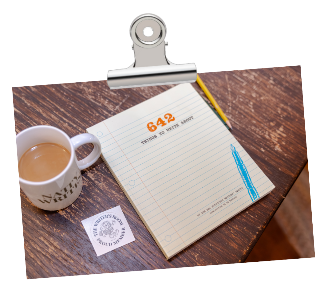 A wooden desk with a lined notepad, a mug of coffee, and a sticker reading "The Writers Room Proud Member" showcasing Natty Writes Blogging Membership