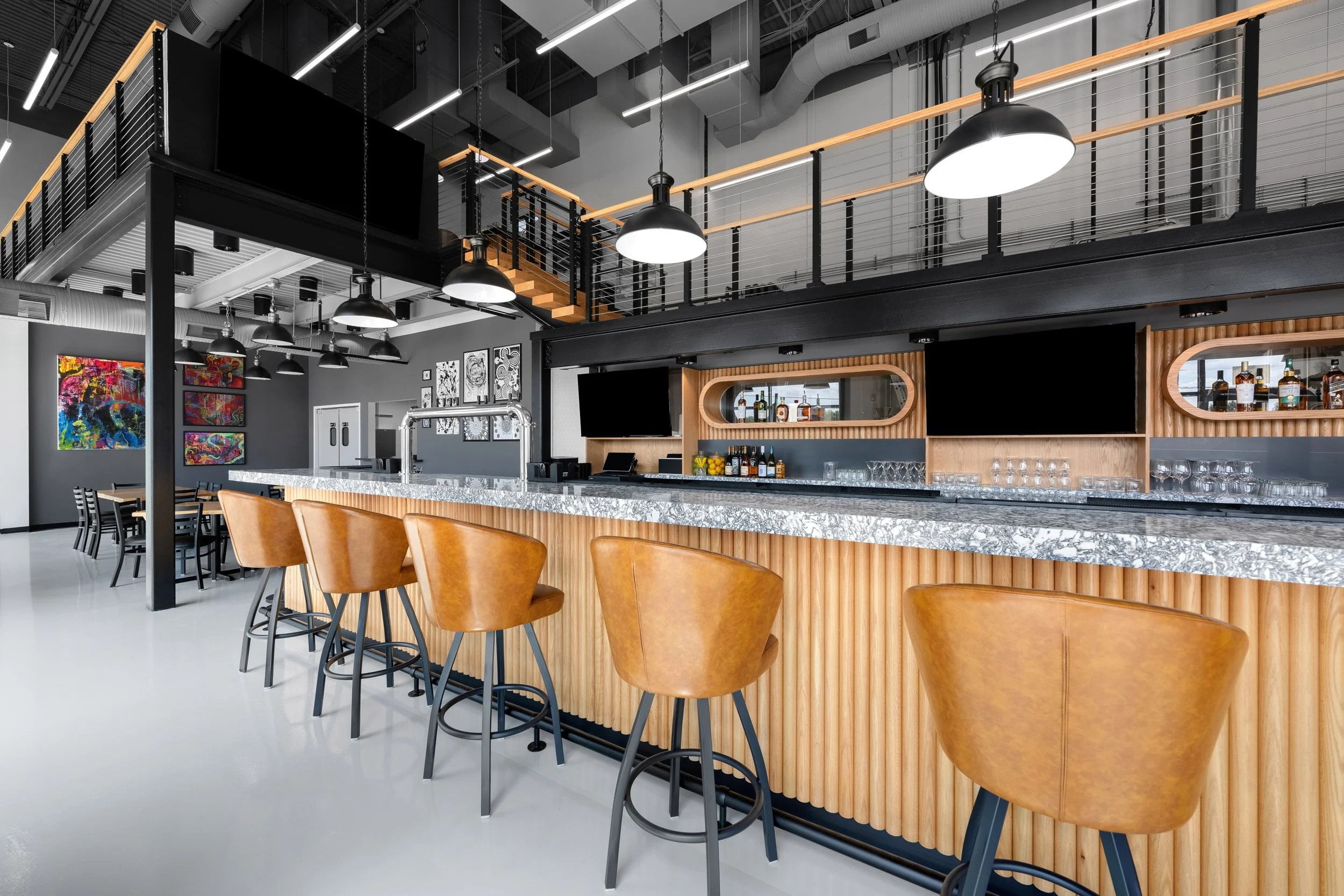 Modern bar with a marble countertop and brown leather bar stools in Reston, VA.