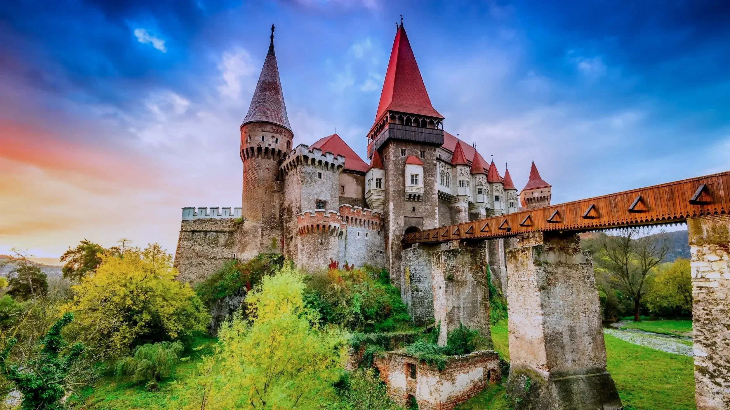 Corvin Castle at sunset with bridge in Romania