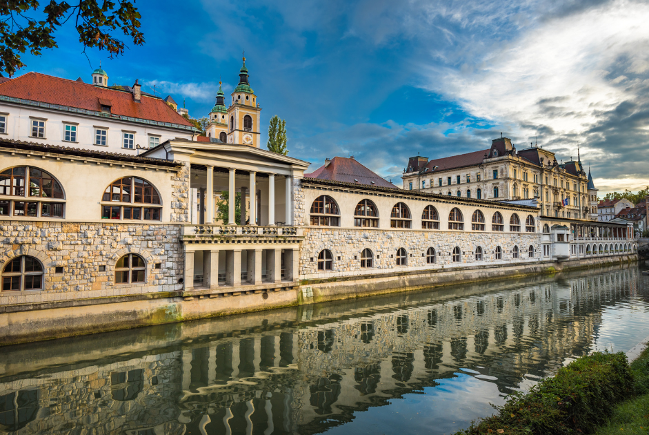 The Central Market reflects in the waters of the canal