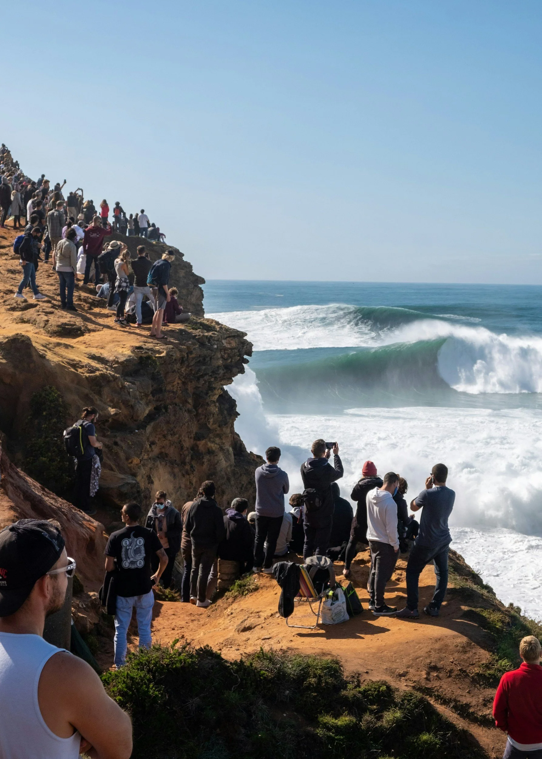 People watching large waves at Nazare