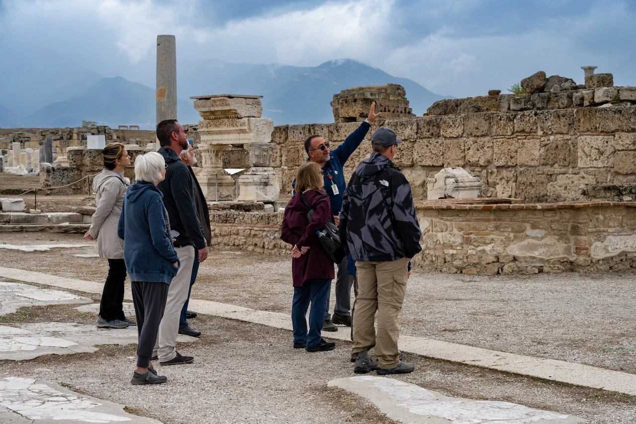 A tour guide explains the history of the ruins