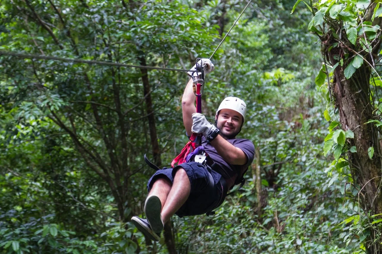 Man on a zip line in the cloud forest of Monteverde Costa Rica
