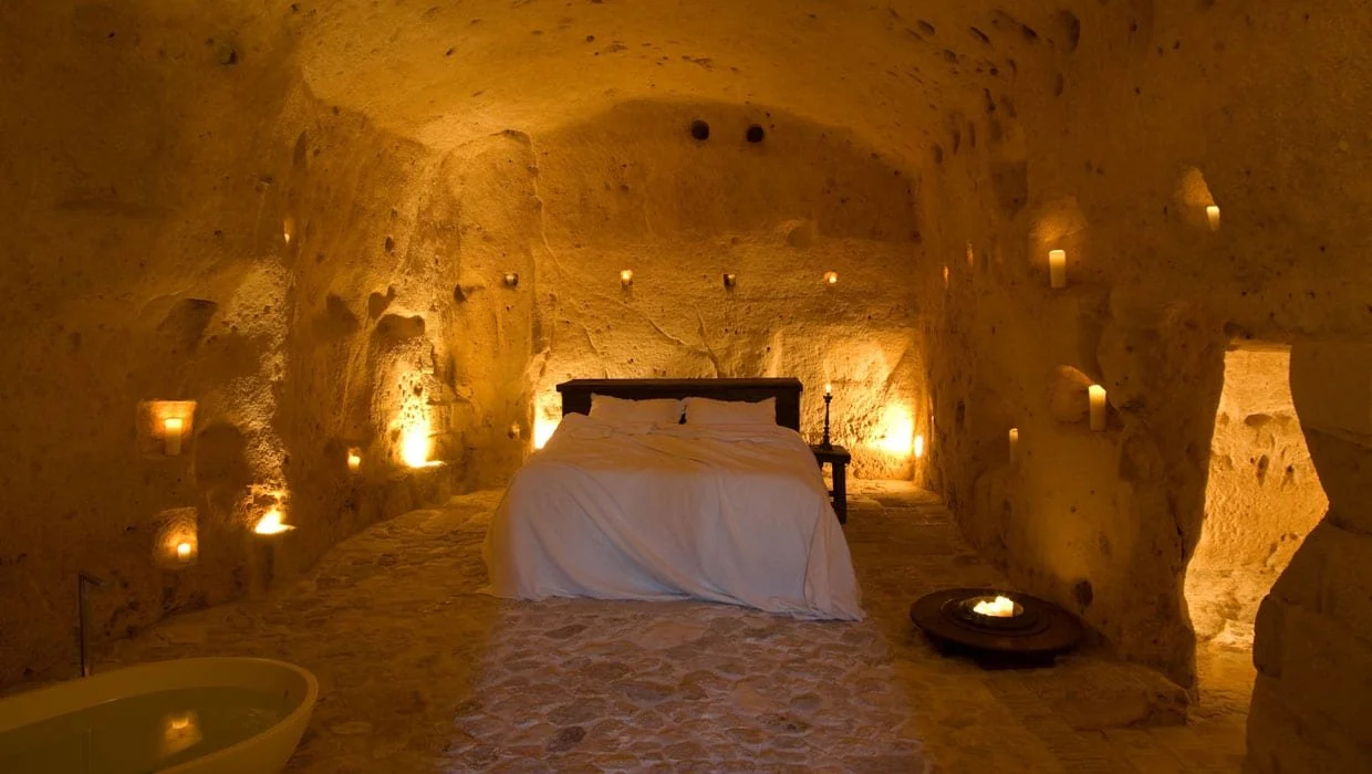 Cave hotel bedroom with warm lighting in Matera