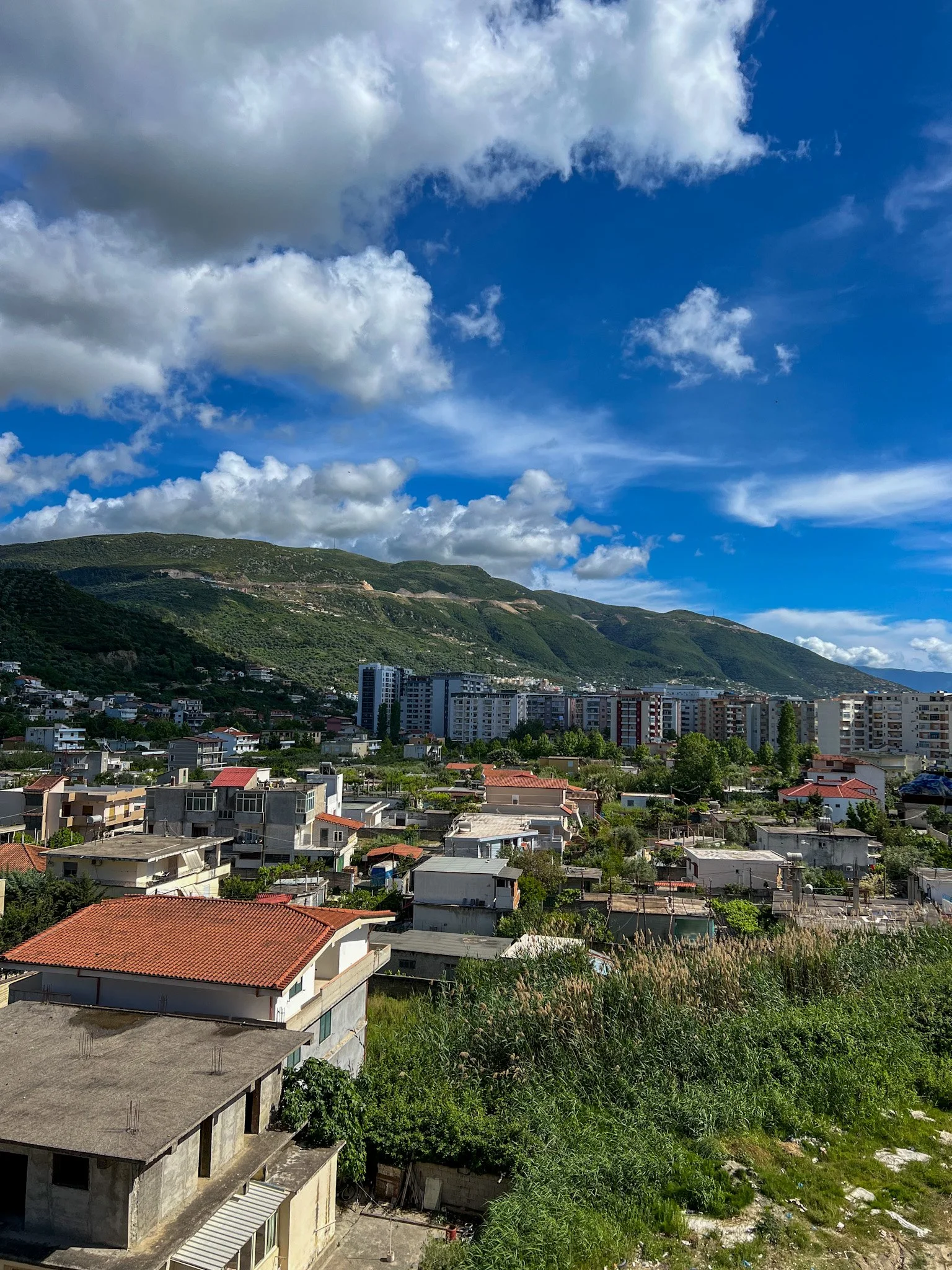 View over the rooftops of Vlore toward green hills, Albania