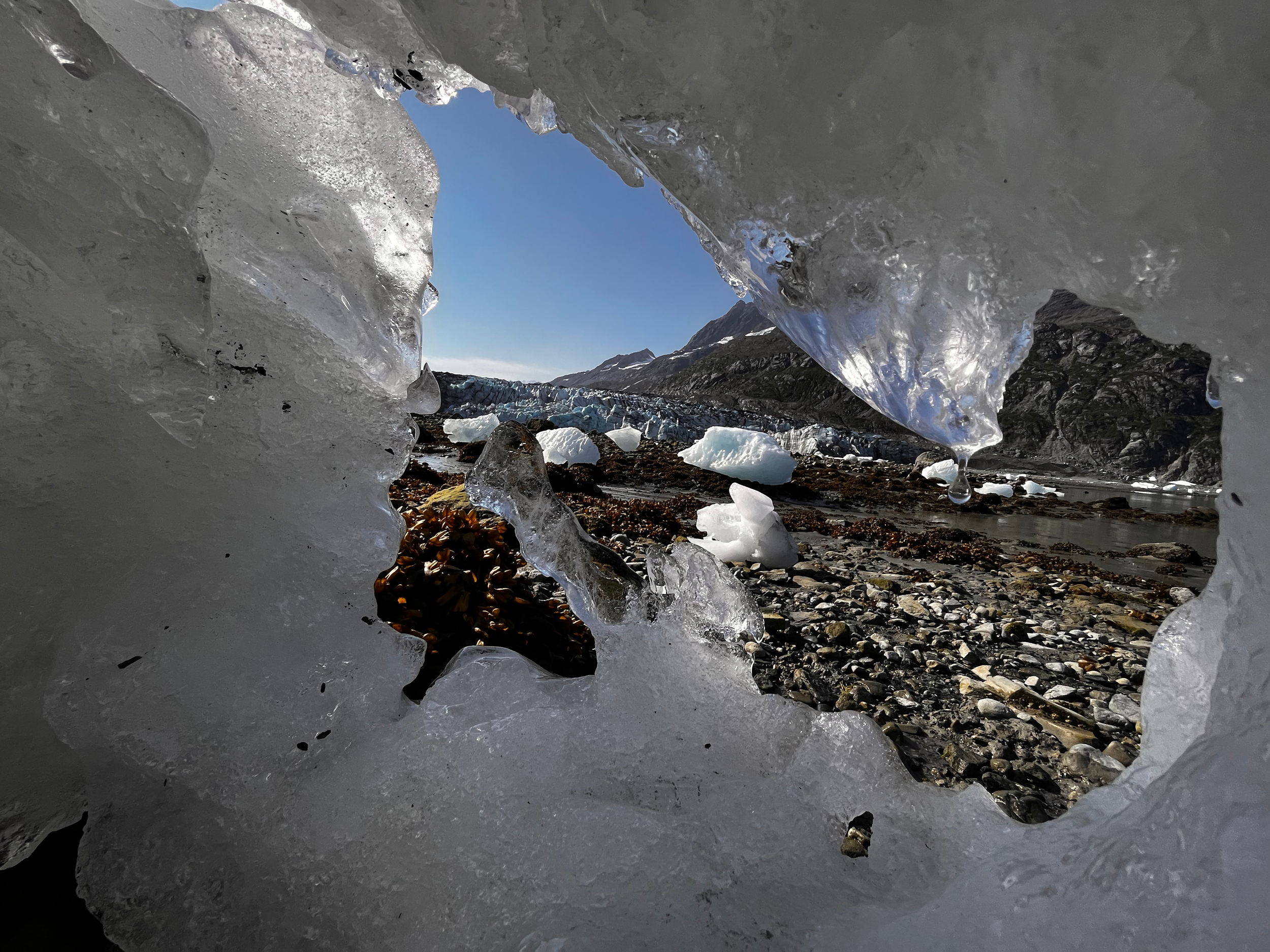 Distant glacier seen through hole in a piece of ice