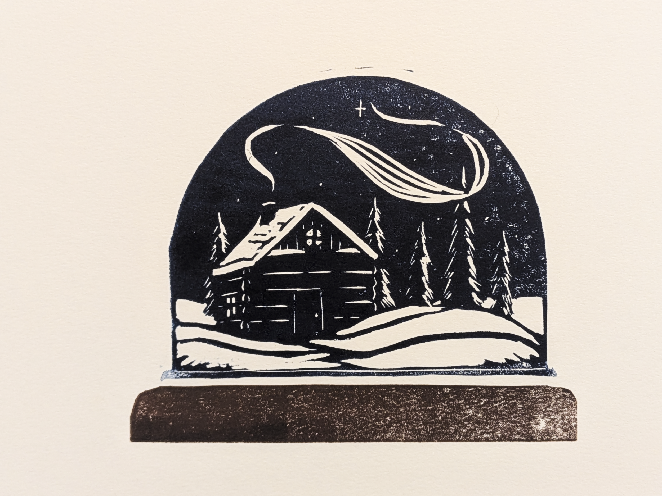 Block Print of a Cabin Inside a Snow Globe