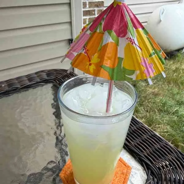 A glass of lemonade with a paper umbrella