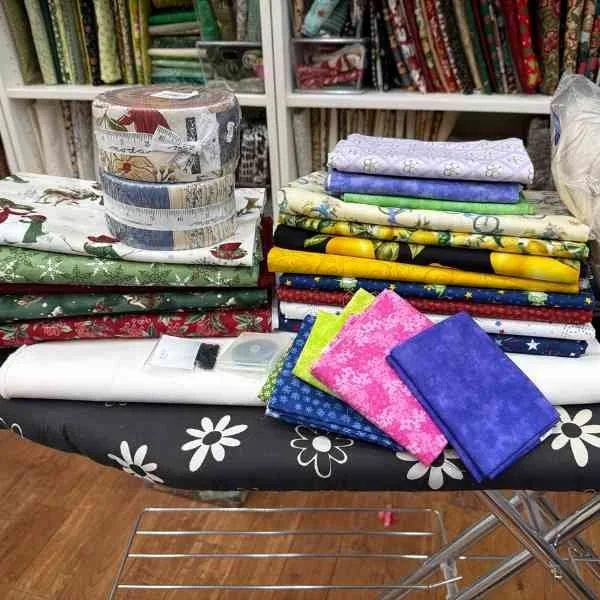 a pile of fabric and sewing supplies