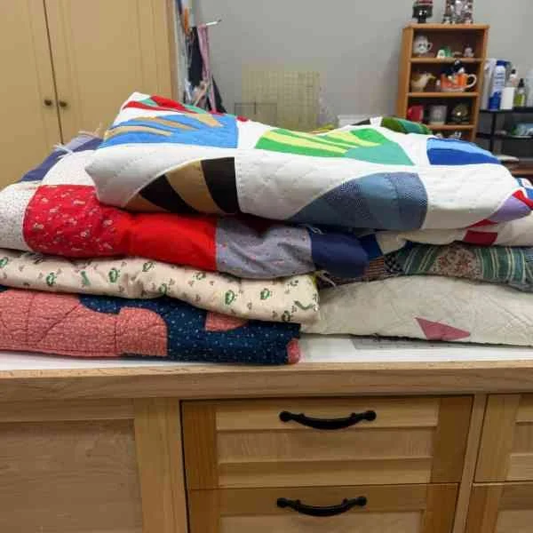 Pile of antique quilts