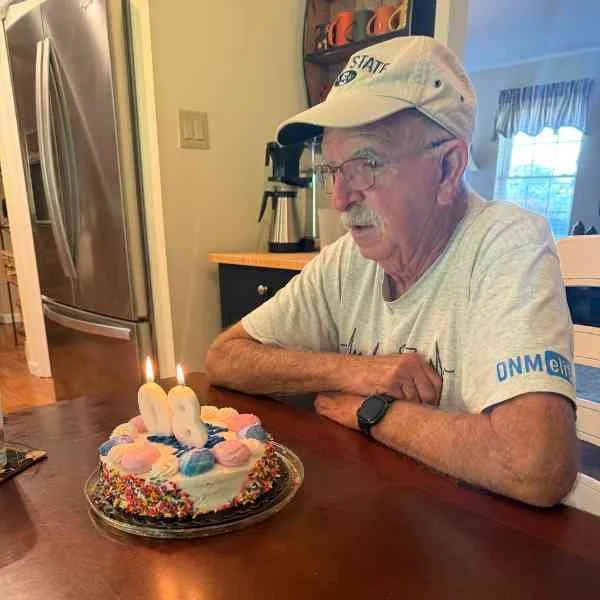 Kris's dad with a cake for his 80th birthday