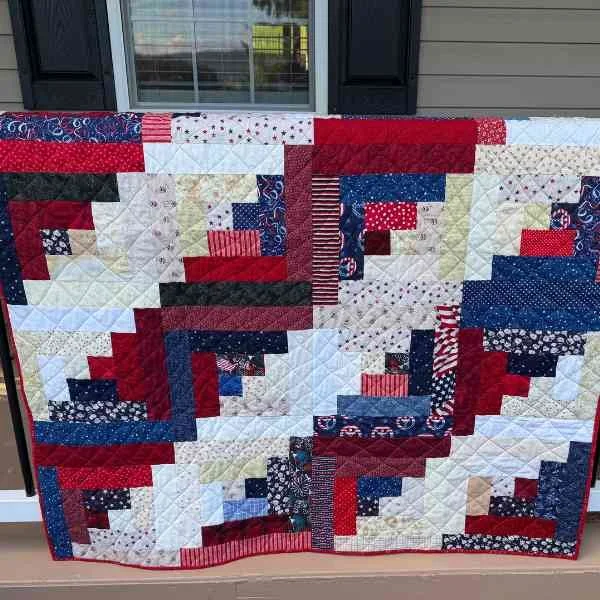 Red, white, and blue log cabin quilt made from scraps