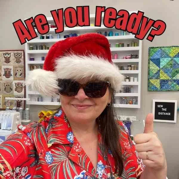 Kris in sunglasses and a Santa hat with the words Are you ready above her head.