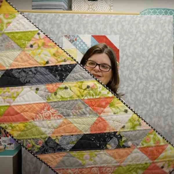 "Charm Pack Quilted Table Runner Tutorial” is a Free Charm Square Table Top Quilt Pattern designed by Kris O'Neill from Sew The Distance!