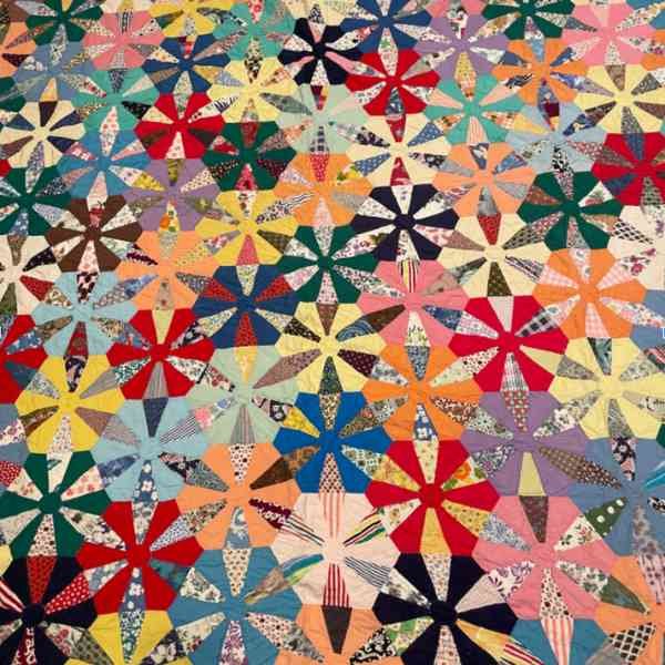 Full image of a bright wagon wheel antique quilt