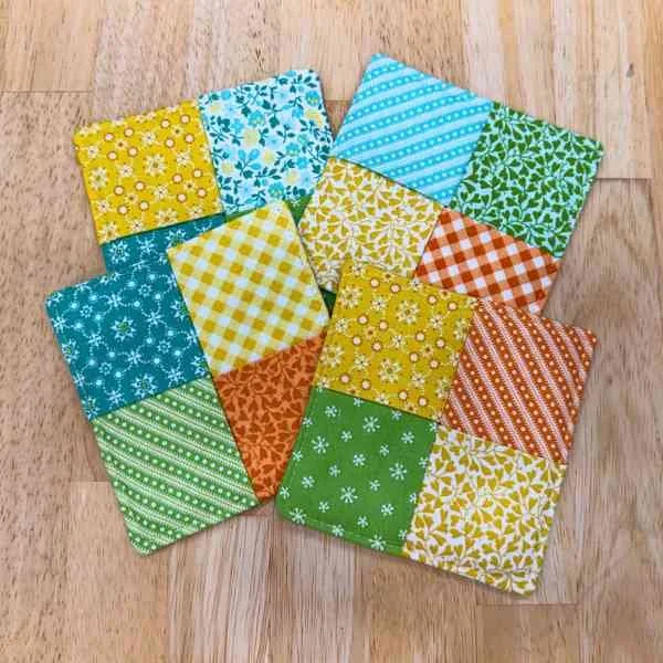 Four folded fabric coasters in bright colors