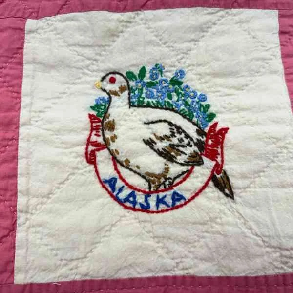 Embroidered Alaska state quilt block with the state bird Willow Ptarmigan and flower forget-me-not state flower